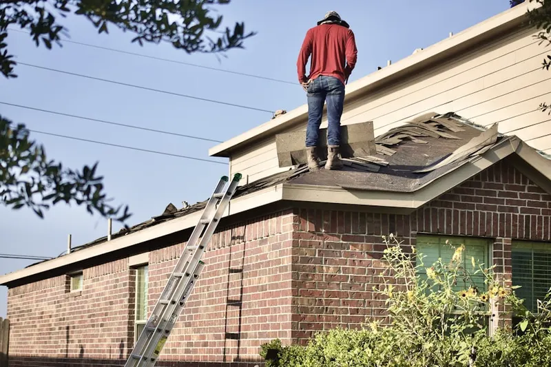 Professional roofer working on a residential roof in Shorb